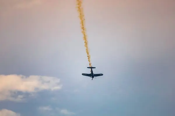 stock image Leszno, Poland - June 16 2023: Antidotum Airshow Leszno 2023 and acrobatic shows full of smoke of Red Bull F4U Corsair on a cloudy sky