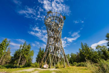 Walbrzych, Poland - August 14 2023: Beautiful high metal and spiral mountain viewing tower on top of Borowa mountain at sunny cloudy day