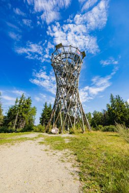 Walbrzych, Poland - August 14 2023: Beautiful high metal and spiral mountain viewing tower on top of Borowa mountain at sunny cloudy day