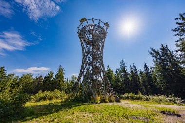 Walbrzych, Poland - August 14 2023: Beautiful high metal and spiral mountain viewing tower on top of Borowa mountain at sunny cloudy day