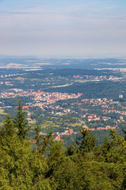 Walbrzych, Poland - August 14 2023: Beautiful panorama of Walbrzych city and a lot of trees around seen from top of viewing tower on top of Borowa mountain