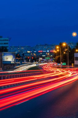 Wroclaw, Poland - August 24 2023: Long streaks of light made by riding cars on the road on the bridge at cloudy afternoon