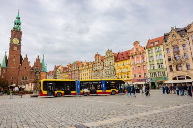 Wroclaw, Poland - August 28 2023: Presentation of new electric bus standing at market square next to town hall with a group of watching it people