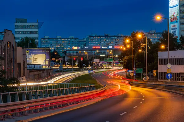 Wroclaw, Poland - August 24 2023: Long streaks of light made by riding cars on the road on the bridge at cloudy afternoon