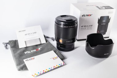 Wroclaw, Poland - December 18 2023: Camera lens for mirrorless Canon camera with RF mount Viltrox RF 85mm f1.8 STM on white background clipart
