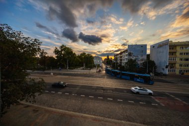 Wroclaw, Polonya - 24 Temmuz 2024: Günbatımında Wroclaw 'ın güzel, geniş bir manzarası at arabaları, tramvaylar ve yenilenmiş eyer çantasından görülen altın ve mavi gökyüzünde akan bulutlar