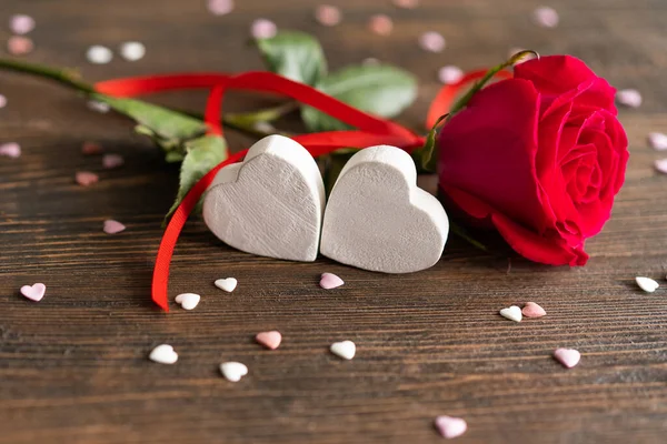 Red rose with postcard on wooden background. Happy Valentines Day postcard. Love concept for mothers day or valentines day. Valentine card with space for text