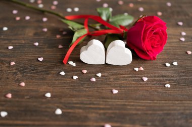 Red rose with postcard on wooden background. Happy Valentines Day postcard. Love concept for mothers day or valentines day. Valentine card with space for text