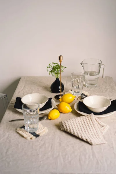 Vintage table setting with Linen napkins and yellow lemons. Decoration table. Close up. Cozy calm meal in the morning in the sunshine.
