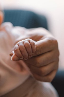 Newborn baby girl sucking milk from mothers breast. Portrait of mom and breastfeeding baby. Concept of healthy and natural baby breastfeeding nutrition.