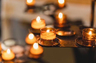 Birçok mum bir katedralde yanıyor. Kilisede dini ayin. İnanç, maneviyat ve din kavramı.