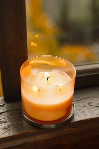 Sweet Home. Still life details in home on a wooden window. Candle and autumn decor. Autumn home decor. Cozy fall mood. Cozy autumn or winter concept.