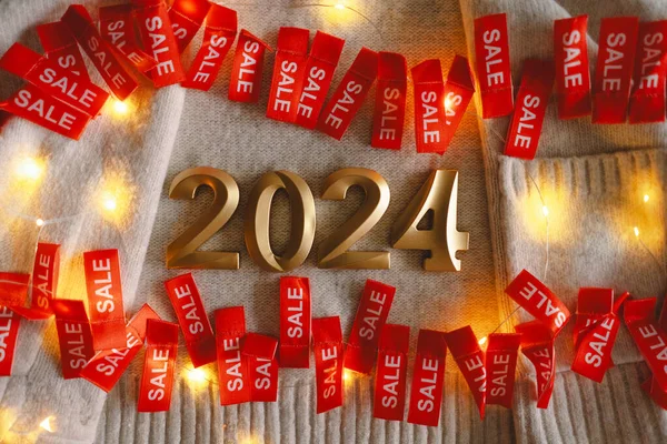 Red sale tag with numbers 2024. Advertising of Black Friday cheap clothes. 2024 season sale concept.