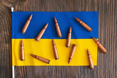 Ukrayna 'nın mavi-sarı bayrağında düzgünce düzenlenmiş birkaç mermi kovanı var. Ukrayna 'da savaş. Ukrayna 'ya silah yardımı kavramı