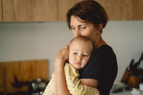 Woman Stands Modern Kitchen Holding Baby Her Arms She Leans Stock Photo