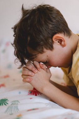 Elleri bağlı bir çocuk, dua ediyor ya da meditasyon yapıyor. Hıristiyanlık, din ve inanç kavramı.