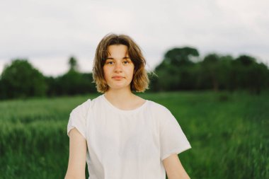 Portrait Of Teenager Girl. Happy Cheerful Teen Girl With Pronounced Face dancing In Outdoors.