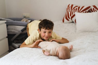 Two little boys brothers enjoying playing in cozy bright bedroom, smiling and playing. Happy childhood. Children portraits.