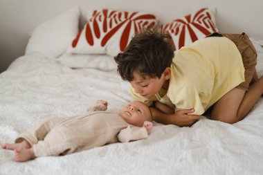 Two little boys brothers enjoying playing in cozy bright bedroom, smiling and playing. Happy childhood. Children portraits.