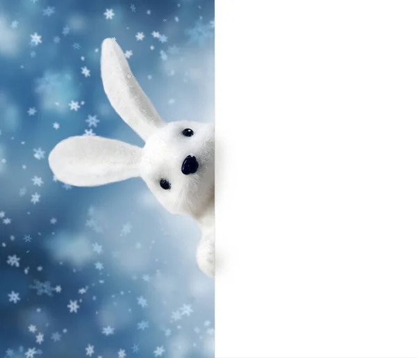 Toy Rabbit Bunny symbol of new year 2023 on the blue background. Inscription HAPPY NEW YEAR 2023. New Year concept
