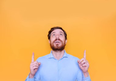 Man isolated pointing up to empty copy space text