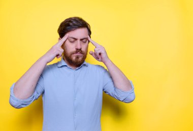 Bearded man focused on a task, keeping him forefingers pointing head.