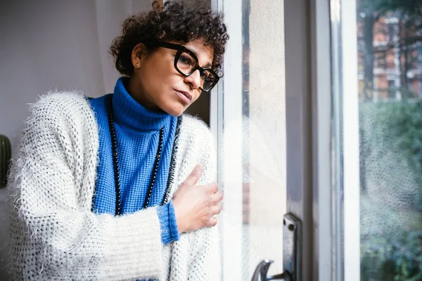 Black woman at home feeling sad and depressed