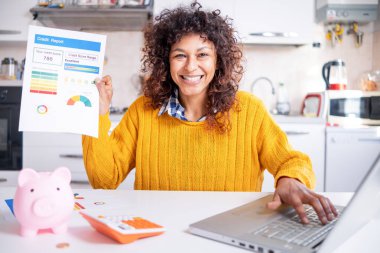 Happy black woman checking her good credit score online