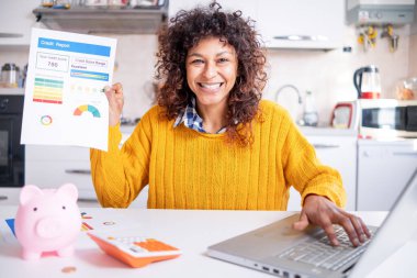 Happy black woman checking her good credit score online clipart