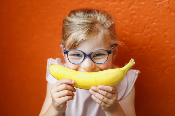 Happy Little Child Girl Yellow Banana Smile Orange Background Preschool — Foto de Stock