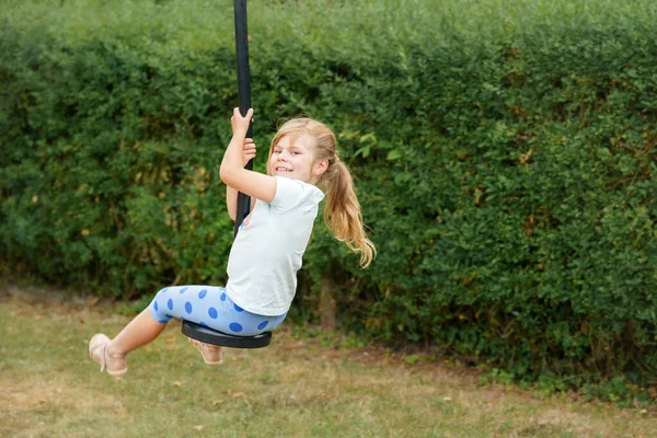 Happy Kid Girl Rids Zip Line Swing Outdoor Game Play — Zdjęcie stockowe