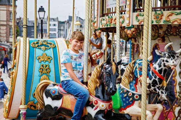 在法国洪福勒市 一个学童骑着老式的旋转木马兜风 十几岁以下儿童玩乐 — 图库照片