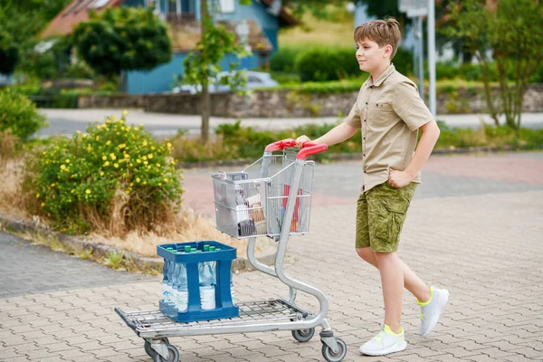 Onfident School Boy Spinge Carrello Della Spesa Attraverso Supermercato Vivace — Foto Stock