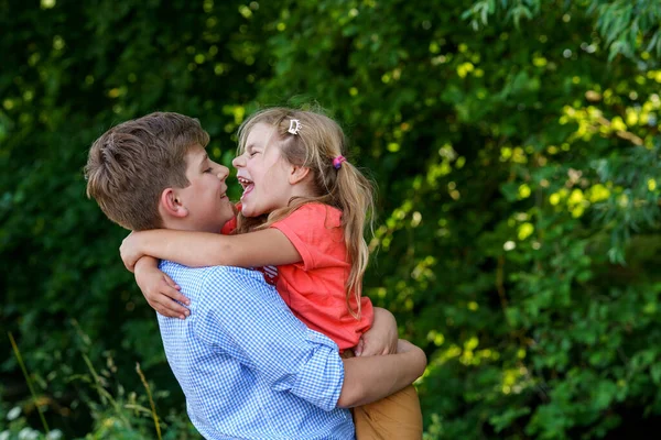 Happy Little Girl Embraces Her Loving Brother Teenager Boy Showcasing — Stock Photo, Image