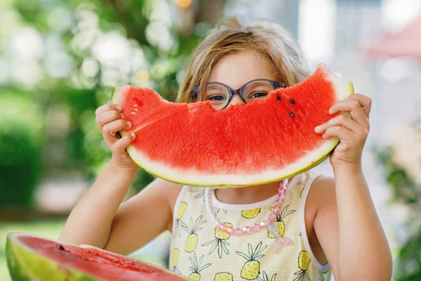 stock image Little Girl, Preschooler, Delights in a Juicy Watermelon on a Sunny Summer Day. Child sharing a Healthy Snack with Her Family, She Embraces the Joy of Summertime Bliss.