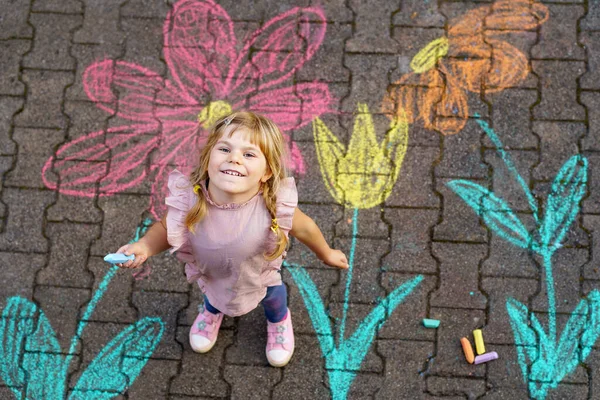 Little Preschool Girl Painting Colorful Chalks Flowers Ground Backyard Positive — Zdjęcie stockowe