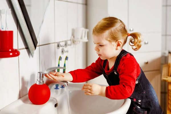 可爱的小女孩在浴室里用肥皂和水洗手 可爱的孩子学习清洁身体的部分 早上的卫生习惯 在家里或托儿所里快乐健康的孩子 — 图库照片