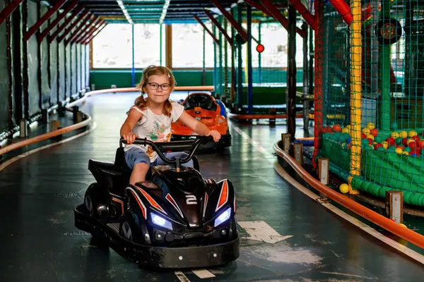 Little Preschool Girl Driving Electric Car Indoor Playground Kids Happy — Stock Photo, Image