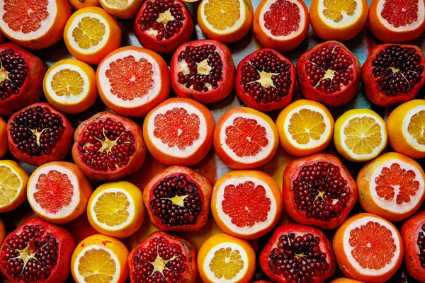 Fresh pomegranate and oranges at the Grand Bazaar, Istanbul. Flatlay view of orange, pomegranate, lemon, grapefruit filtered image.
