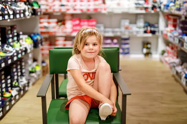 Happy Little Girl Carefully Selects Purchases New Shoes Store Trying — Stock Photo, Image