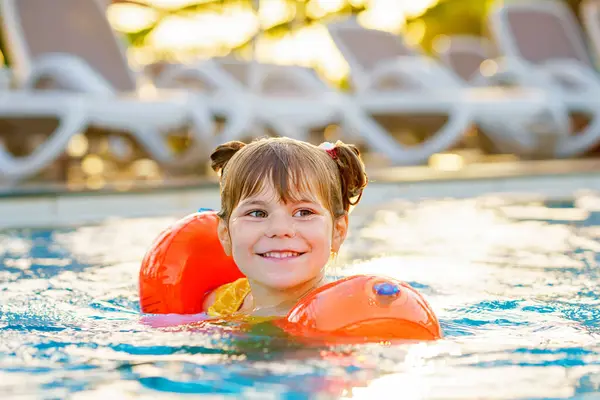 Pequena Menina Pré Escolar Com Nadadeiras Protetoras Brincando Piscina Pôr Fotos De Bancos De Imagens