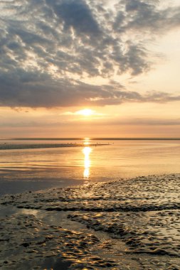 Wattenmeer, mud tideland in North Sea, Germany. Nordsee, Watt by sunset clipart