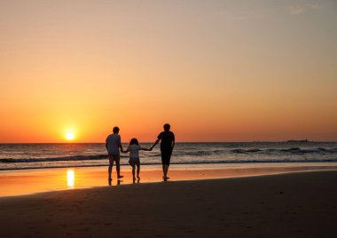 Three kids silhouettes running and jumping on beach at sunset. happy family, two school boys and one little preschool girl. Siblings having fun together. Bonding and family vacation clipart