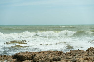 Yazın güneşi gökyüzünde ve kumsalın kumları, manzaranın