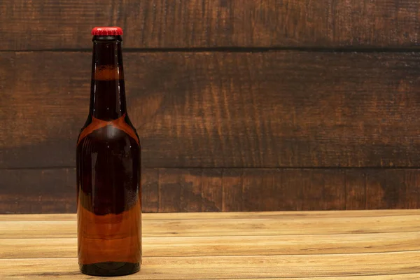 stock image Beer bottle with wooden background