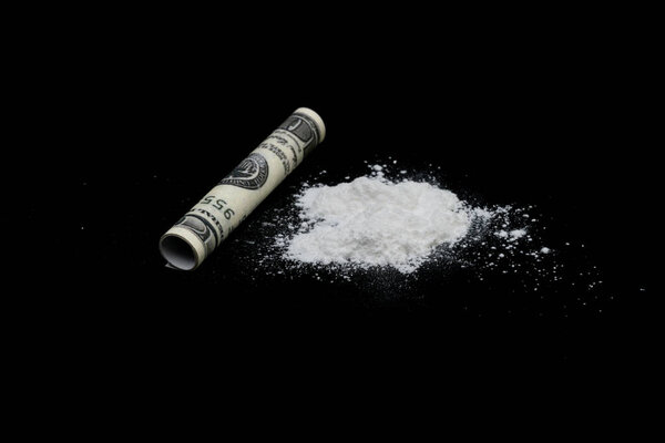 Cocaine or other illegal drugs, white powder, syringe, isolated on black glossy background