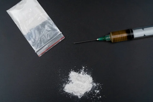 stock image Cocaine or other illegal drugs, white powder, syringe, isolated on black glossy background