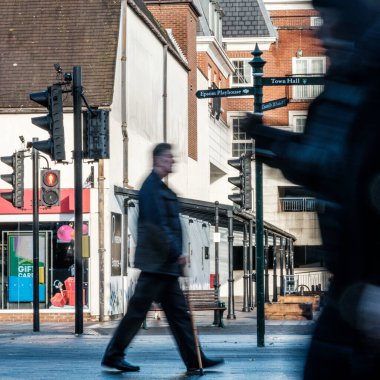 Epsom, Surrey, Londra İngiltere, 20 Kasım 2022, Yürüyen Çubukla Yürüyen Adam ve bir diğeri de bir şehir merkezinde cep telefonu ya da akıllı telefon kullanıyor.