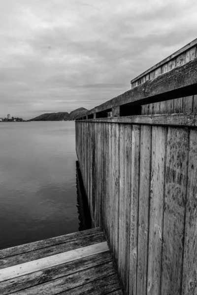 stock image Sandnes, Norway, May 18 2023, Abstract Black And White Monochrome Image Wooden Dock Board Walk Structure At Waters Edge