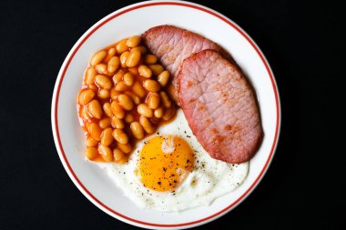 26 Haziran 2025 'te Londra' da domuz pastırmalı kızarmış yumurta ve domates soslu fasulye.